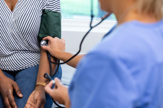 photo - Nurse Using Stethoscope during Medical Examination