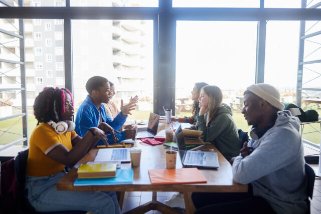 photo - College Students Studying around a Cafeteria Table